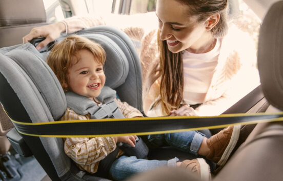A joyful toddler in the UPPAbaby Knox convertible car seat in Jordan fashion, featuring a rear-facing setup for enhanced child safety on the road.
